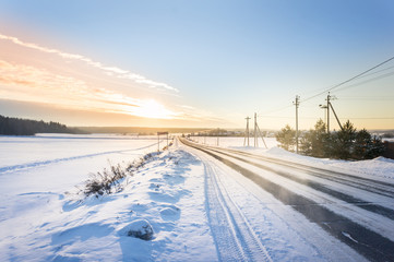 Fototapeta na wymiar snow country road in sunset