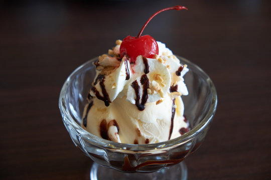 Ice Cream Chocolate And Vanilla Sundae Topping With Red Cherry.