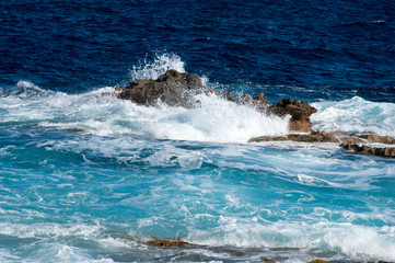 Fototapeta premium A wave and rocks at Malta near Cirkewwa Ferry Terminal.