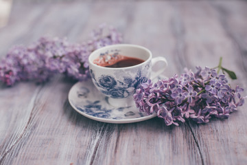 Creative layout is made with lilac with cup of coffee..Nature concept.
