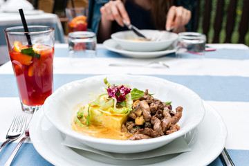 Roasted meat and vegetables. goulash and potato gratin in sauce. selective focus on the filling close-up.