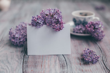 Creative layout is made with lilac with paper card note.Nature concept.Flat lay.