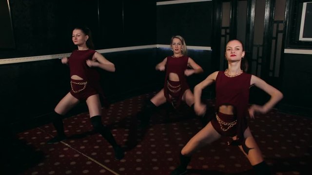 Three sexy girls dance twerk in a dark room moving Asses.