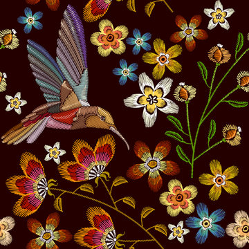 Humming bird and flowers embroidery seamless pattern. Beautiful hummingbirds and spring flowers embroidery on black background. Template for clothes, textiles, t-shirt design