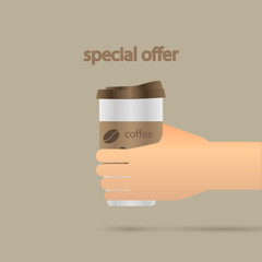 A hand holds a mug of coffee or a drink. Break for a cup of coffee.