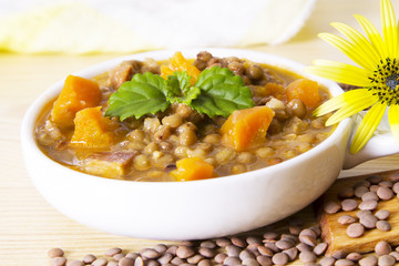 Lentil casserole on wooden table on yellow tablecloth