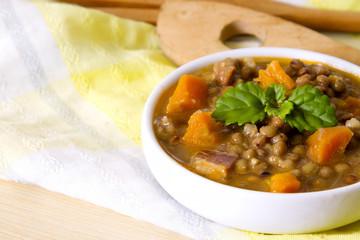 Lentil casserole on wooden table on yellow tablecloth