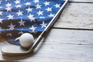 Golf ball with flag of USA on wood table