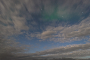 Polar lights, the aurora and the stars visible through the clouds.