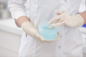 Close up of hands touching female forehead with the Microcurrents