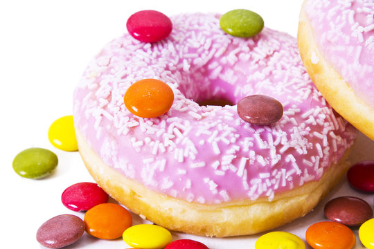 Donuts with candies isolated on white