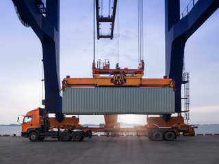 Closeup the spreader type twin lift of container crane at industrial port.