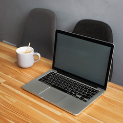 coffee cup and laptop in office table