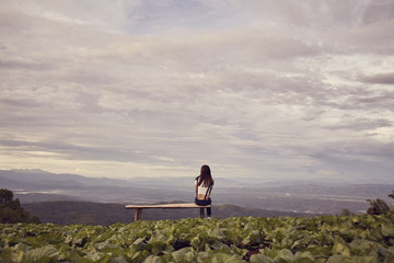 Obraz premium Woman watching scenic natural beauty with mountains and fog.