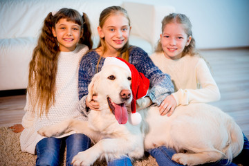 Children playing with a dog