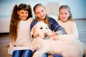 Children playing with a dog
