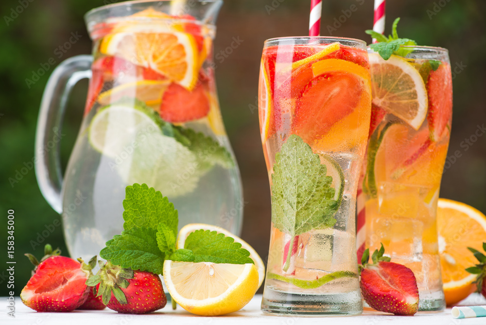 Wall mural mineral water with pieces of fruit in glass