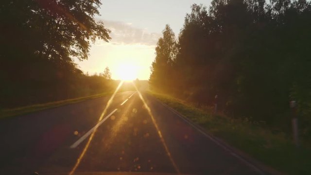 A trip on a rural road in the sunset