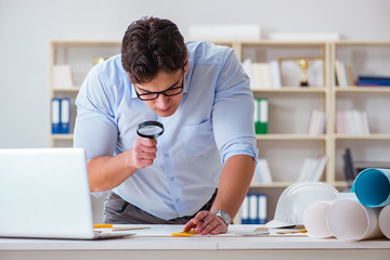 Male engineer working on drawings and blueprints