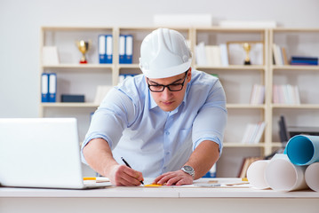 Male engineer working on drawings and blueprints