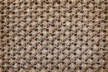 background texture of a knitted fabric with a raised pattern closeup