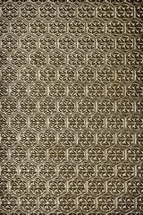 gold background embossed pattern on glass closeup