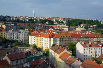 Obraz premium Vinohrady district, Zizkov television communications tower and transmitter in the background, Prague, Czech Republic - aerial view of streets and quarter of Czech capital city