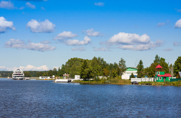 River cruise ship at pier in village Goritsy near Goritsky Voskresensky Monastery in Vologda region