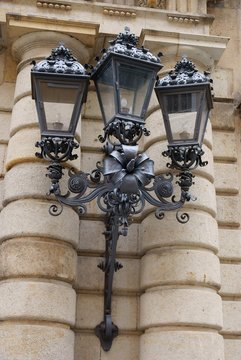 ornamental,metalic street lamp on building