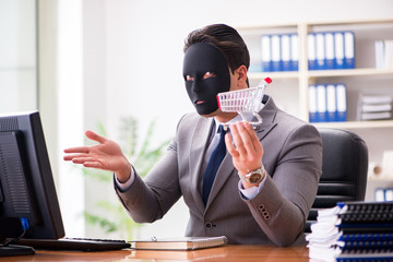 Businessman with mask in office hypocrisy concept