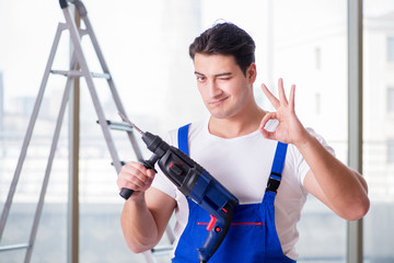 Young worker with hand drill