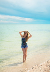 Fototapeta na wymiar Stylish woman at the summer beach in a hot day.