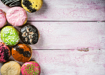 Glazed donuts with different fillings on a wooden table