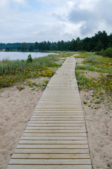 Wooden path along the sandy shore of the Baltic Sea
