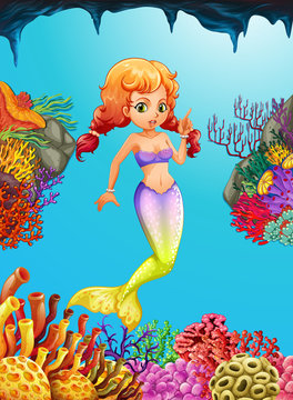 Cute mermaid swimming under the ocean