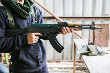 Man hold assault rifles