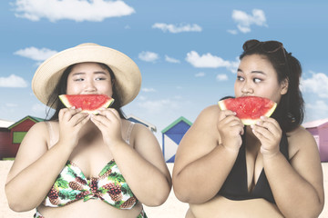 Women eating watermelon near cottage