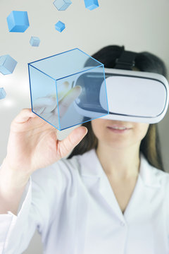 Young cheerful woman with vr headset. Woman in VR headset looking up and trying to touch objects in virtual reality.  Businessman toched a social network button on touch screen. 