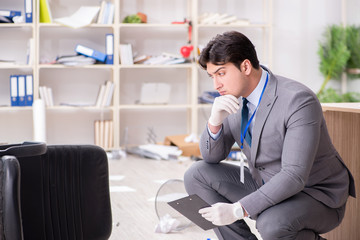 Young man during crime investigation in office