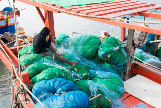 A man resting on fishing net
