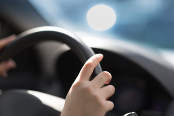Close up of woman hands driving a car
