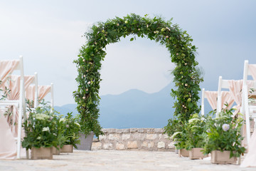decorated arch and chairs at the wedding venue