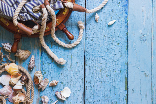 Striped bag, wheel and maritime decorations on the wooden background