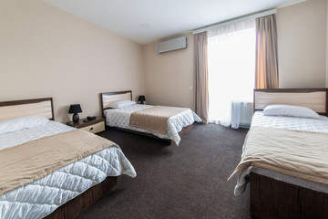 Triple room in modern hotel