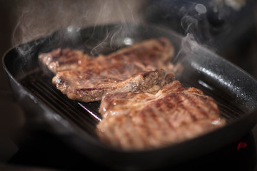 fried beef steak in frying pan
