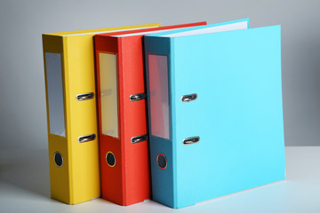 Colorful office folders on grey background