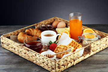 breakfast on table with waffles, croissants, coffe and juice