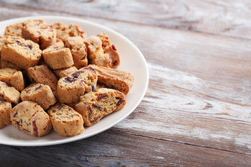 Cantuccini cookies in plate on brown wooden table