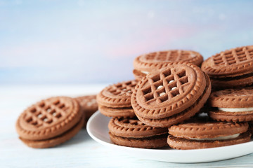 Chocolate cookies with cream on white wooden table