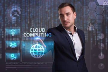 The concept of business, technology, the Internet and the network. A young entrepreneur working on a virtual screen of the future and sees the inscription: Cloud computing